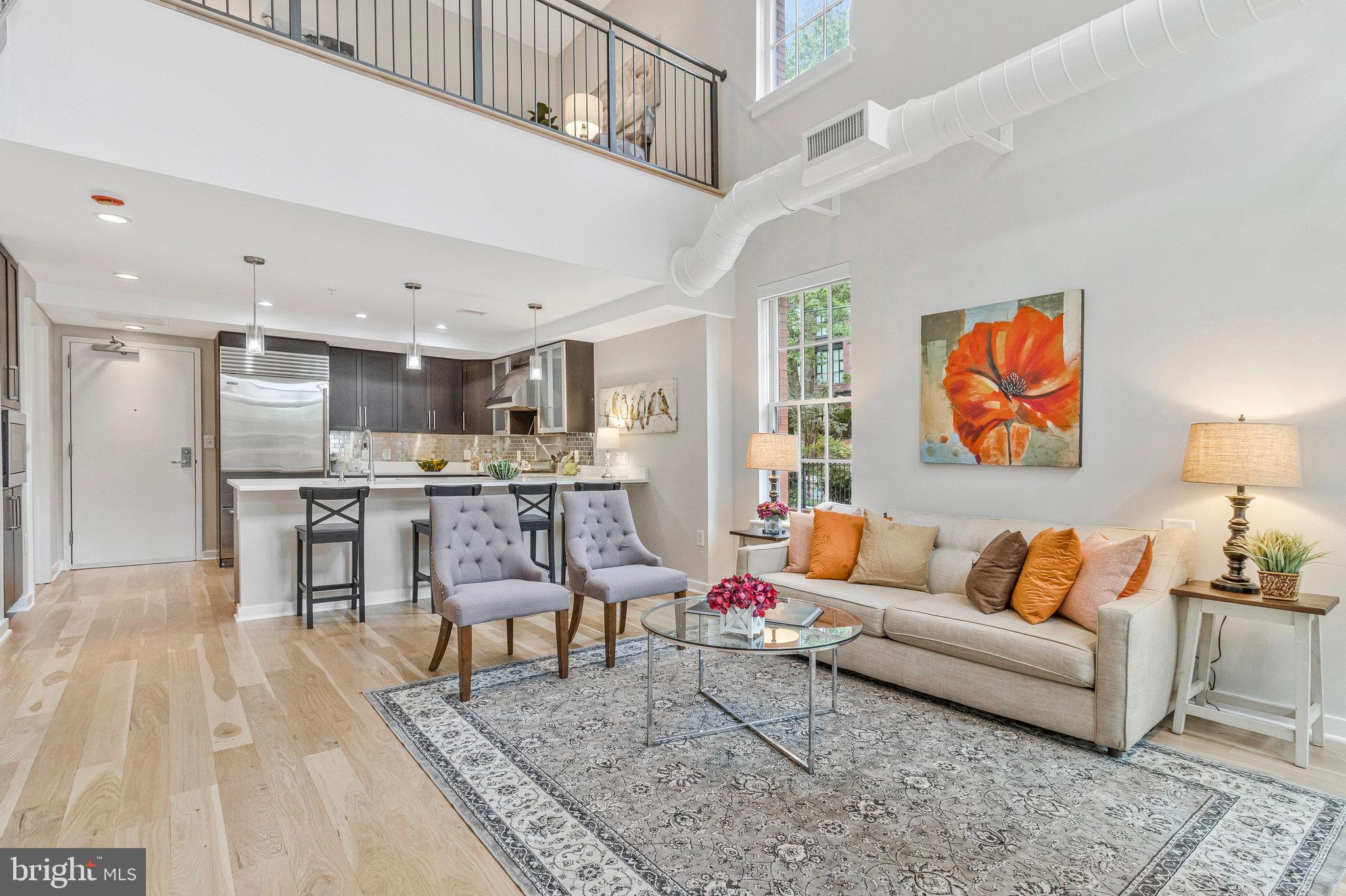 1610 North Queen Street, Unit 211 Arlington, VA 22209 - Photo 5 of 43 a living room with furniture and kitchen view