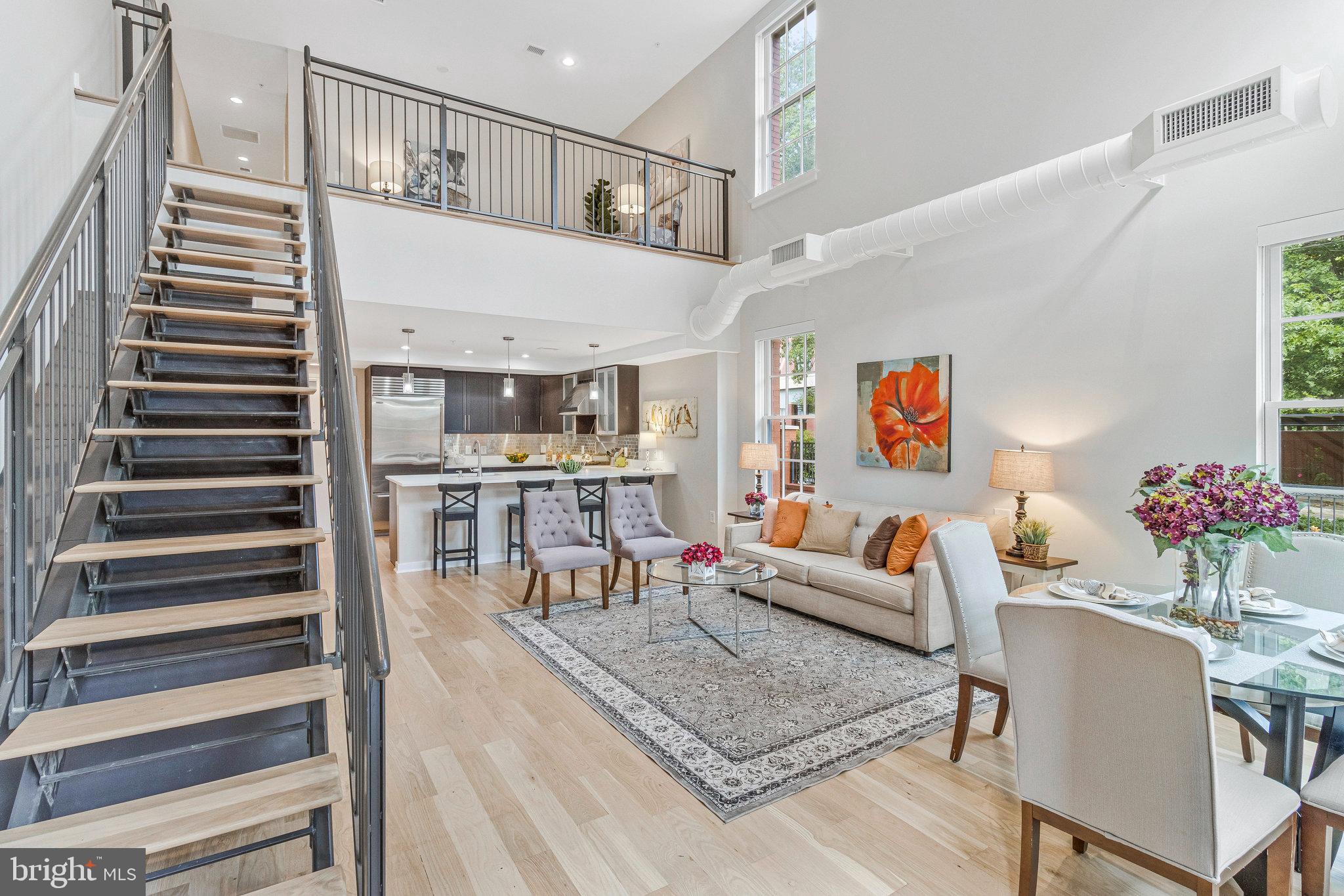 1610 North Queen Street, Unit 211 Arlington, VA 22209 - Photo 6 of 43 a living room with furniture and wooden floor