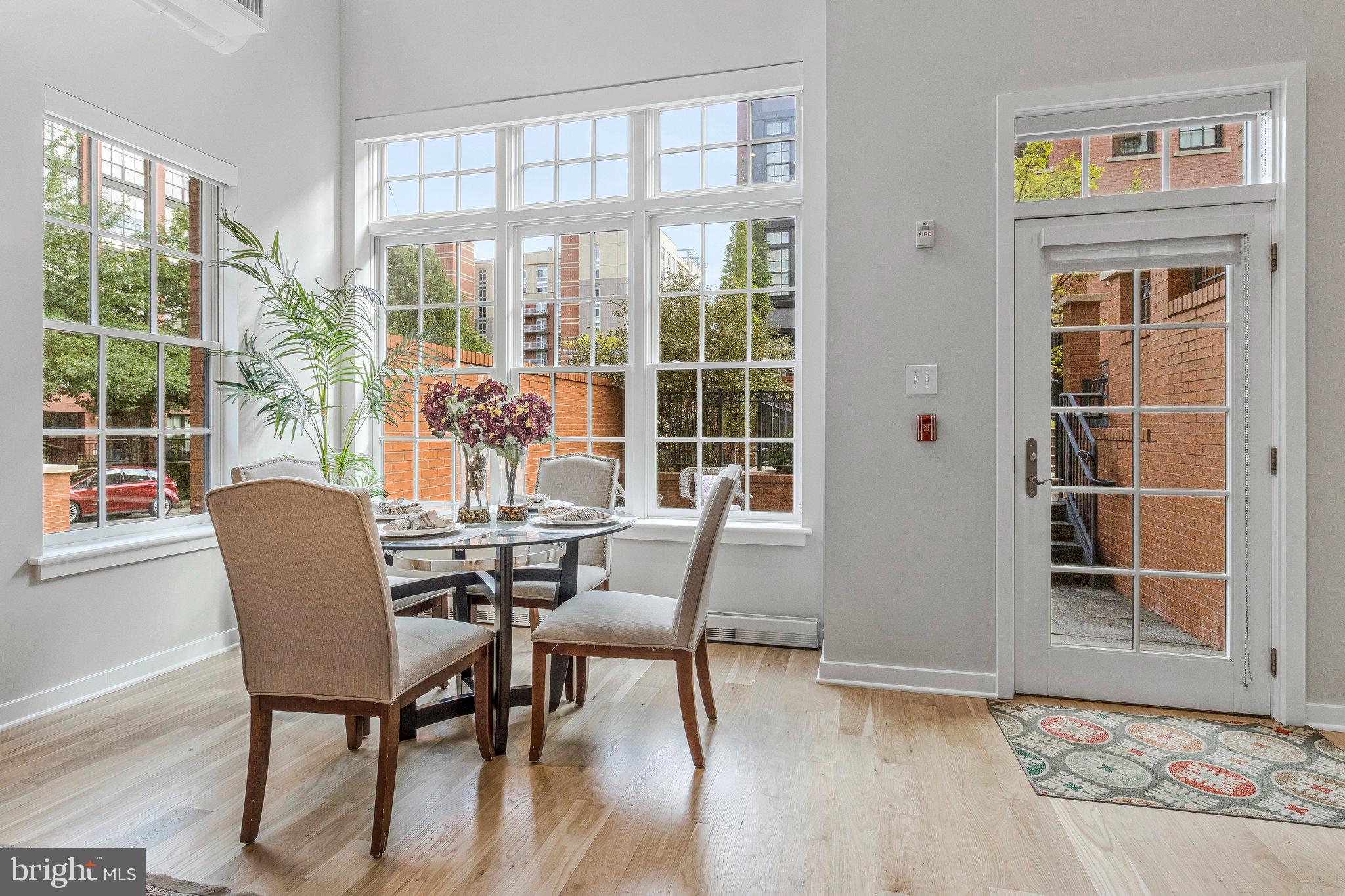 1610 North Queen Street, Unit 211 Arlington, VA 22209 - Photo 7 of 43 a view of a dining room with furniture window and outside view