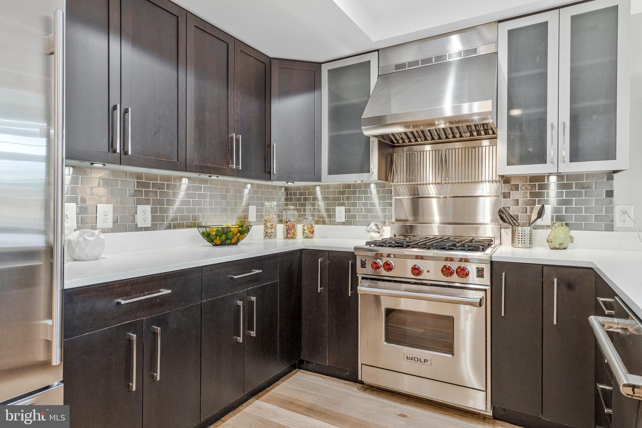 1610 North Queen Street, Unit 211 Arlington, VA 22209 - Photo 9 of 43 a kitchen with a stove top oven and sink