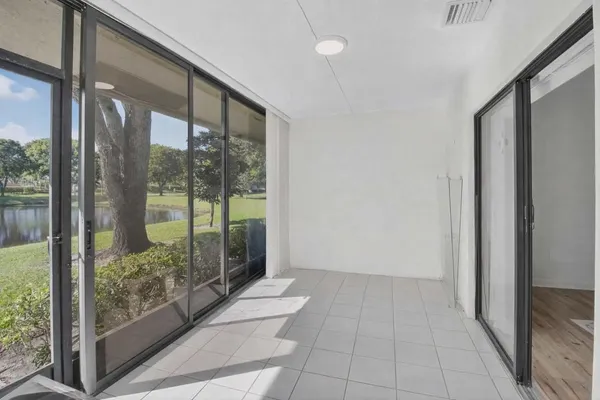 a view of a glass door with wooden floor