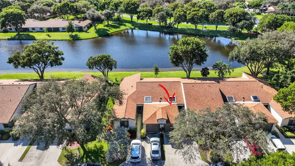 an aerial view of a house with outdoor space and lake view
