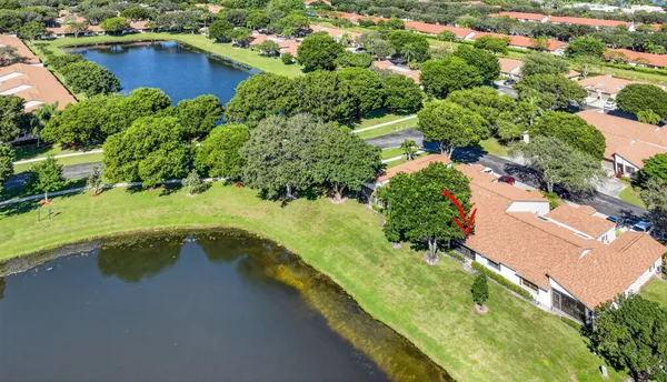 an aerial view of residential houses with outdoor space and swimming pool