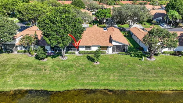 an aerial view of residential houses with outdoor space and trees