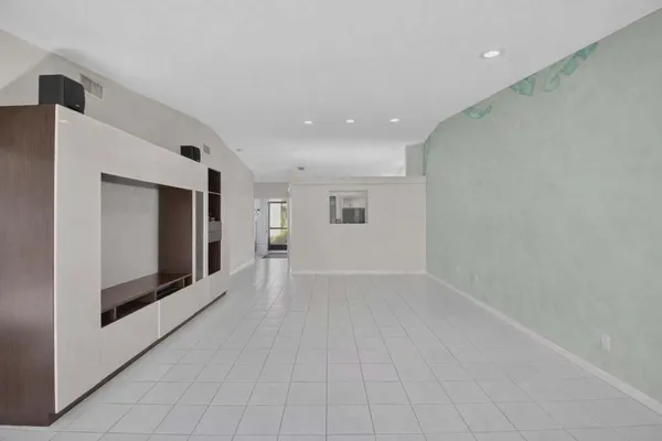 a view of a hallway with an empty room and fire place