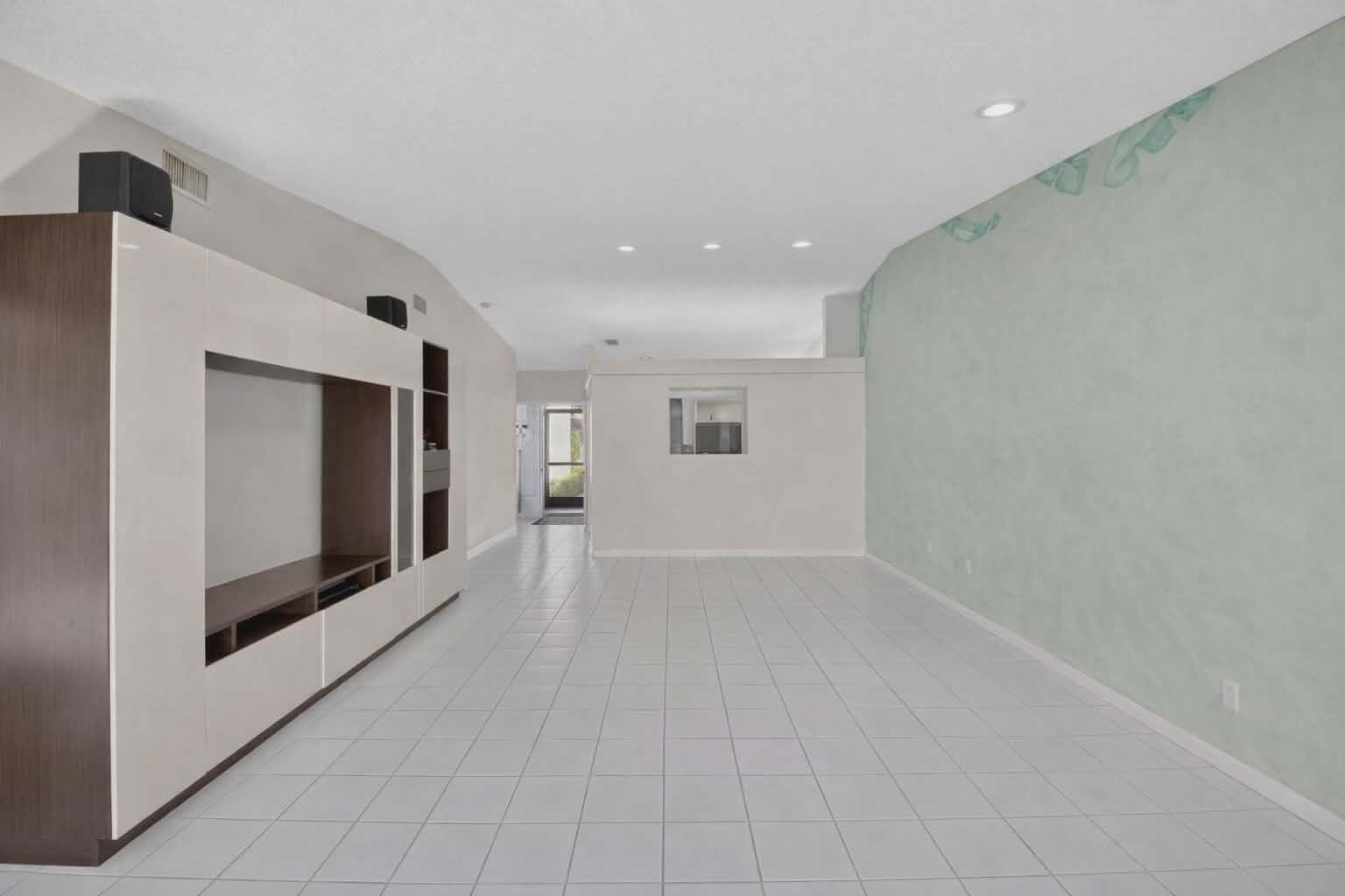 8146 Windgate Drive Boca Raton, FL 33496 - Photo 7 of 24 a view of a hallway with an empty room and fire place
