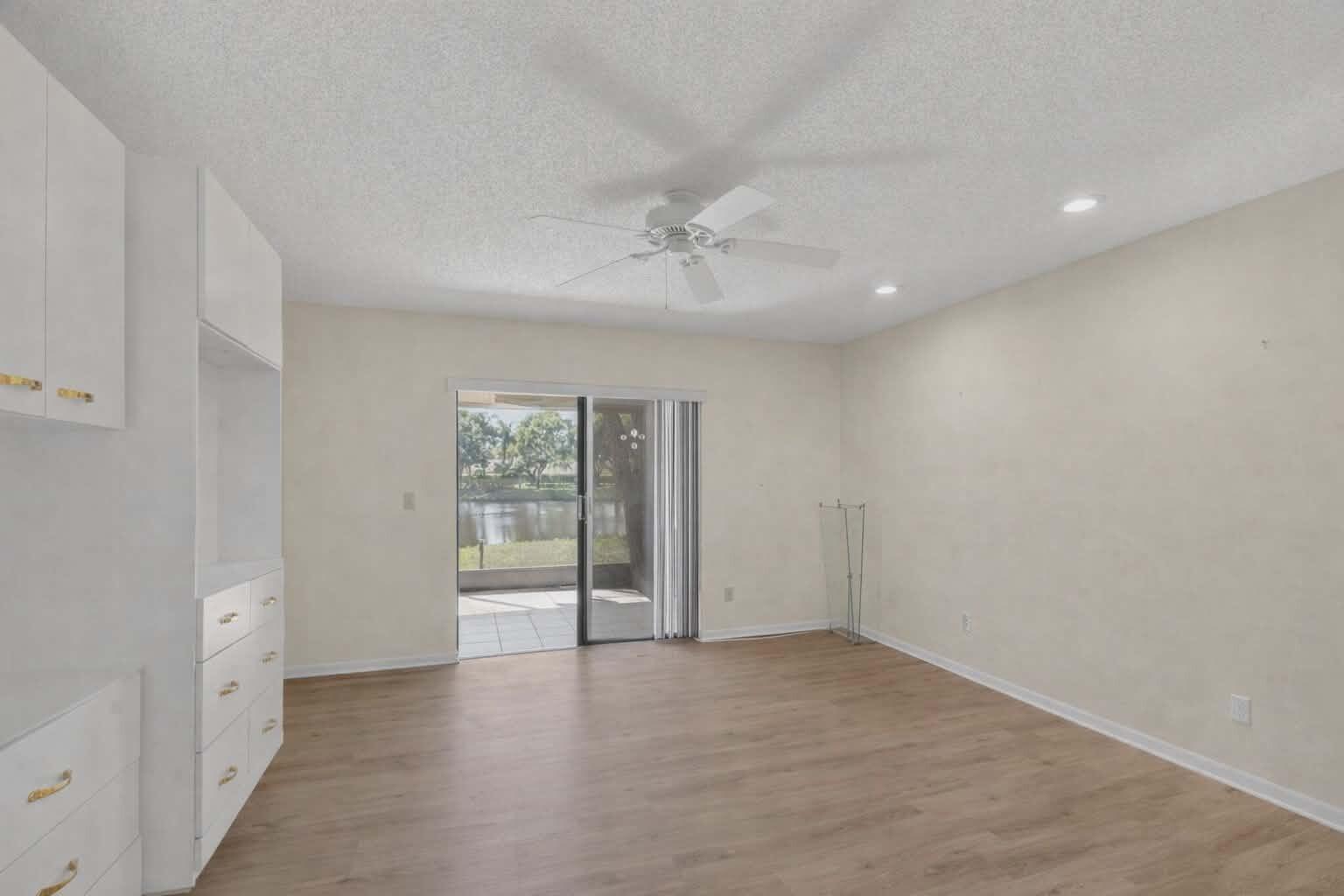8146 Windgate Drive Boca Raton, FL 33496 - Photo 9 of 24 wooden floor in an empty room with a window