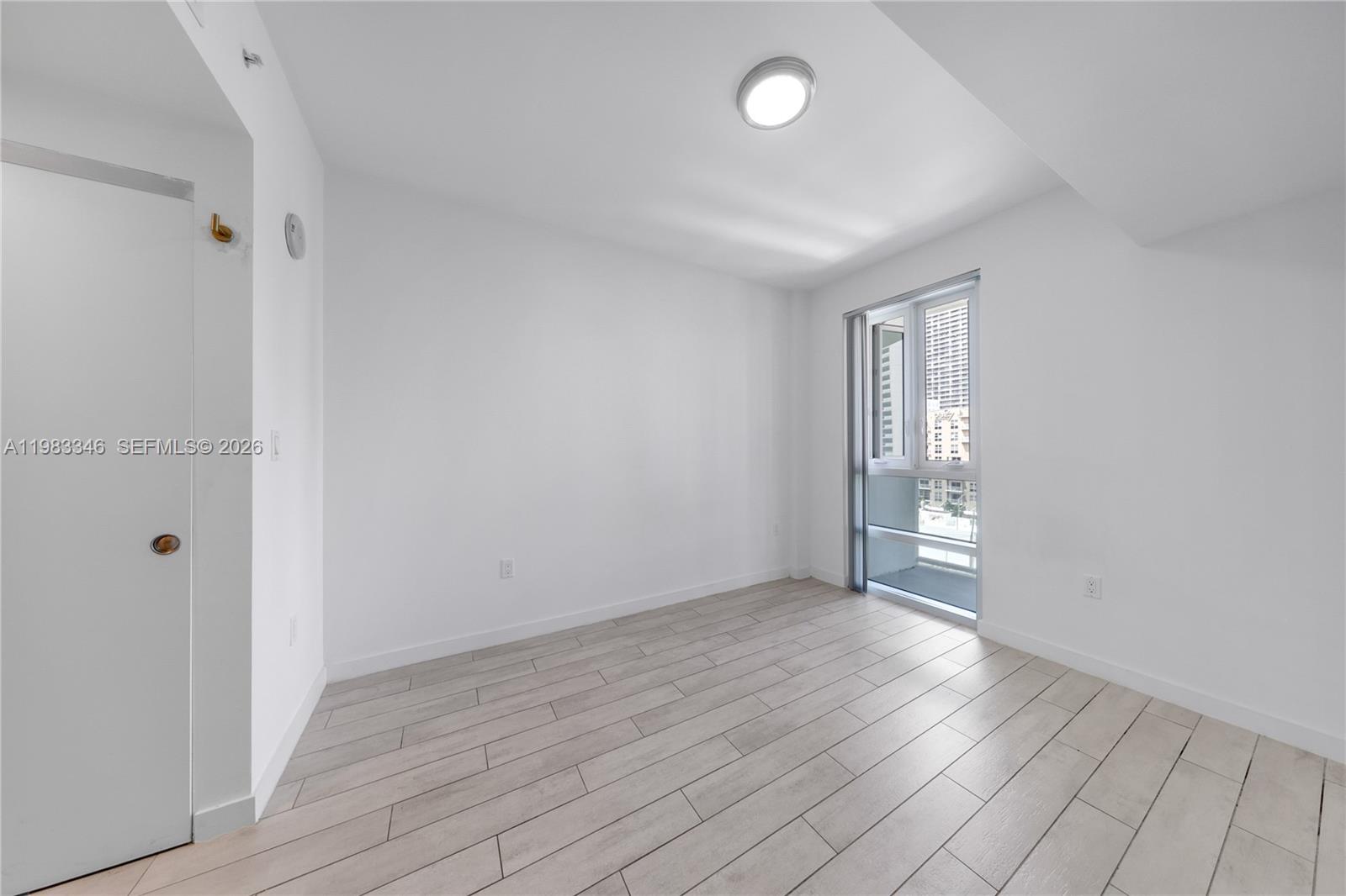 321 Northeast 26th Street, Unit 701 Miami, FL 33137 - Photo 13 of 24 a view of an empty room with wooden floor