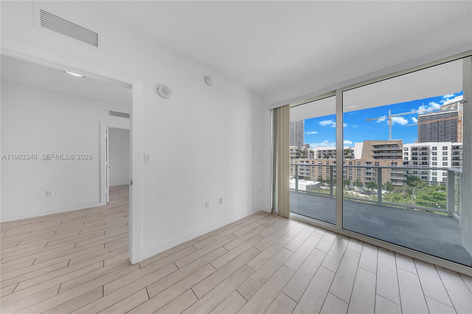 321 Northeast 26th Street, Unit 701 Miami, FL 33137 - Photo 7 of 24 a view of a room with wooden floor and a window