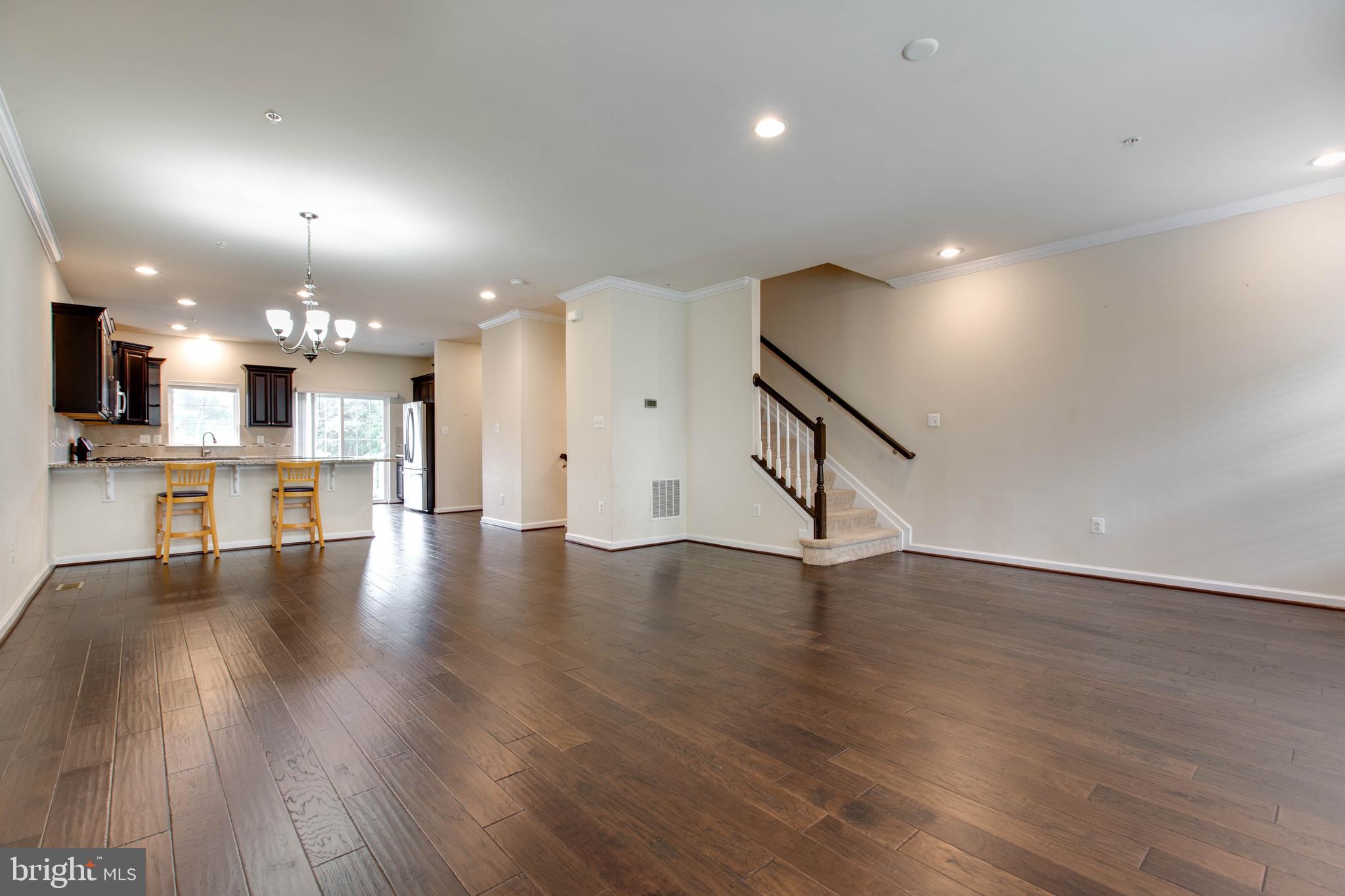 7048 Foxton Way Hanover, MD 21076 - Photo 12 of 52 a view of a kitchen with furniture and a wooden floor