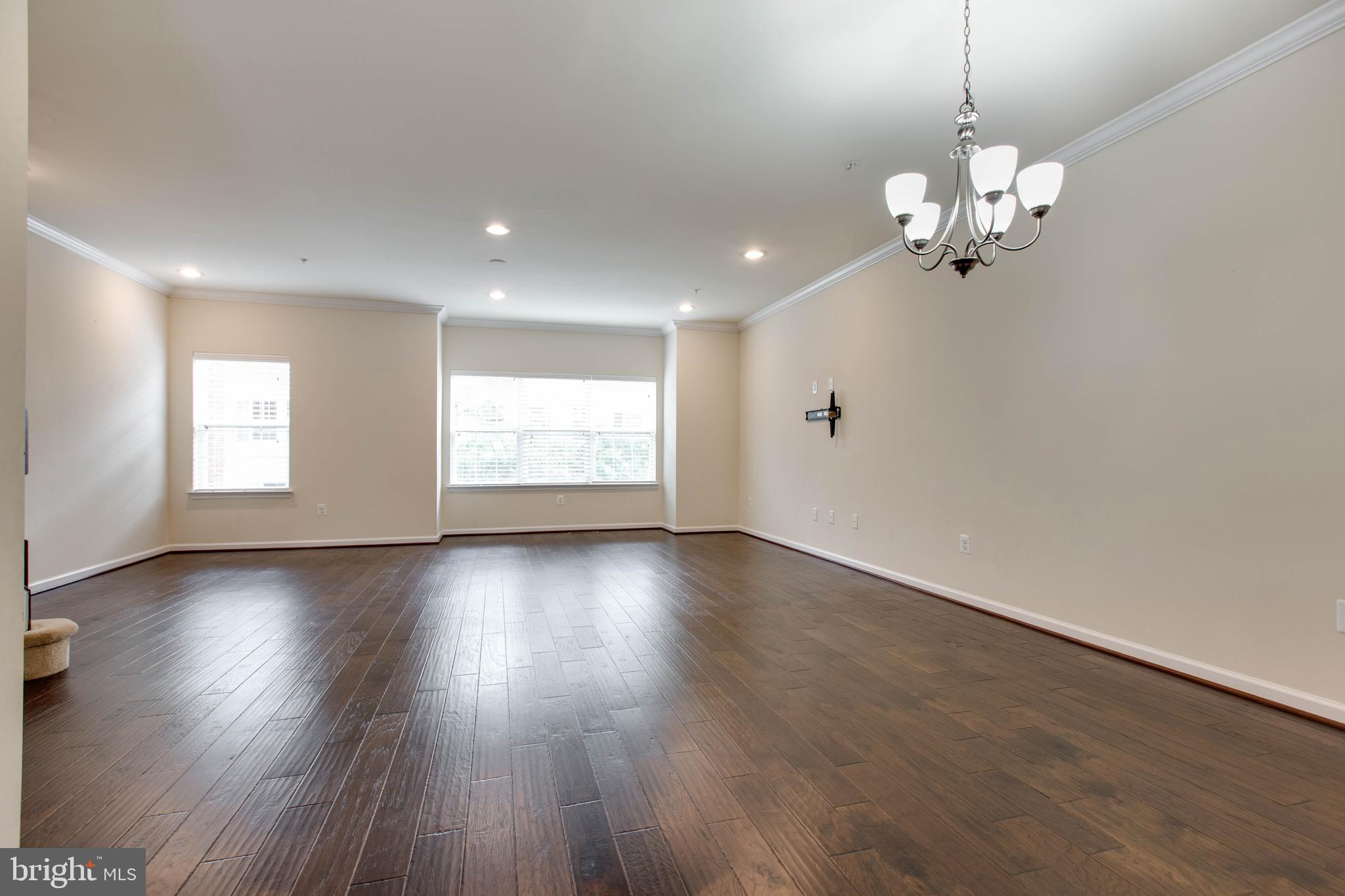 7048 Foxton Way Hanover, MD 21076 - Photo 14 of 52 a view of an empty room with wooden floor and a window