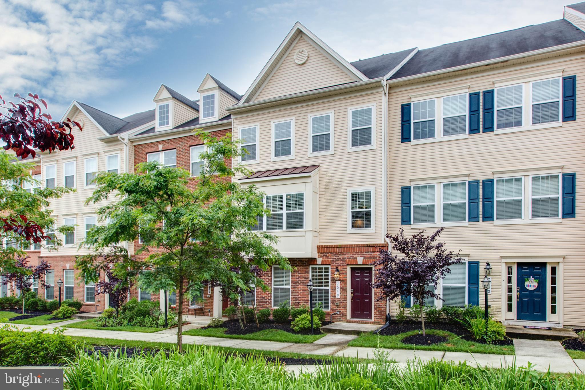 7048 Foxton Way Hanover, MD 21076 - Photo 2 of 52 front view of a house with a yard