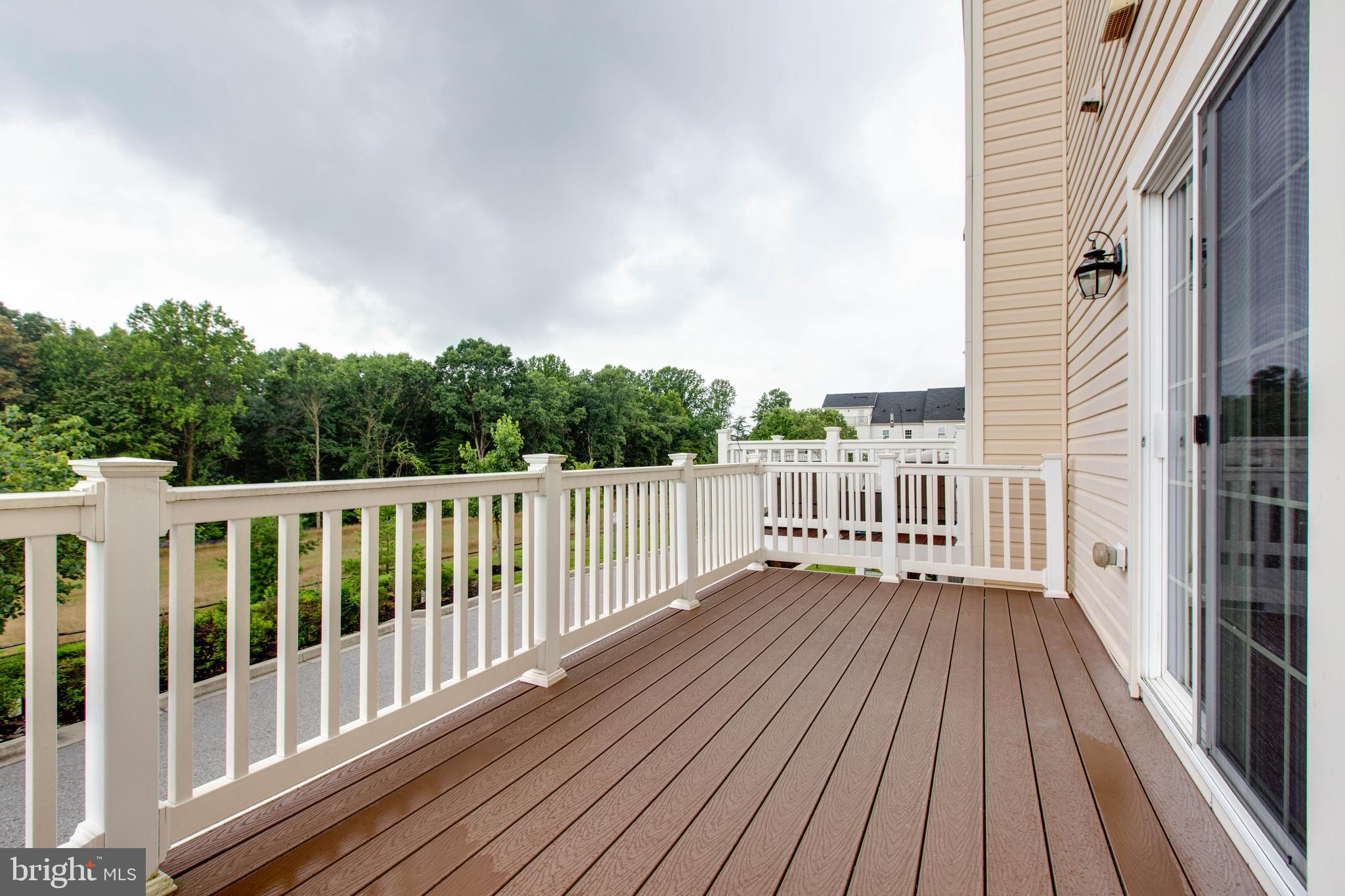 7048 Foxton Way Hanover, MD 21076 - Photo 22 of 52 a view of a wooden deck with a yard