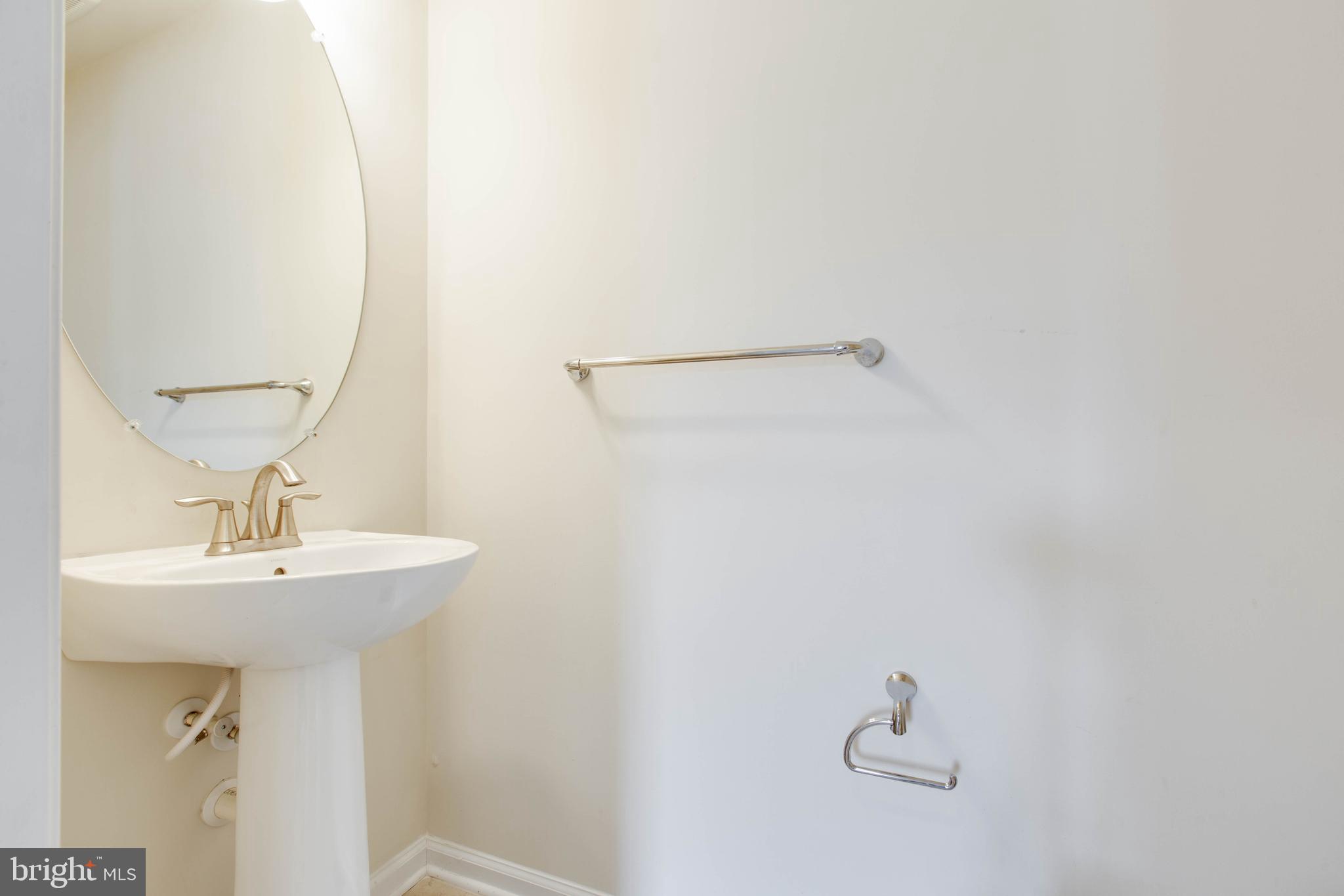 7048 Foxton Way Hanover, MD 21076 - Photo 44 of 52 a bathroom with a sink and mirror