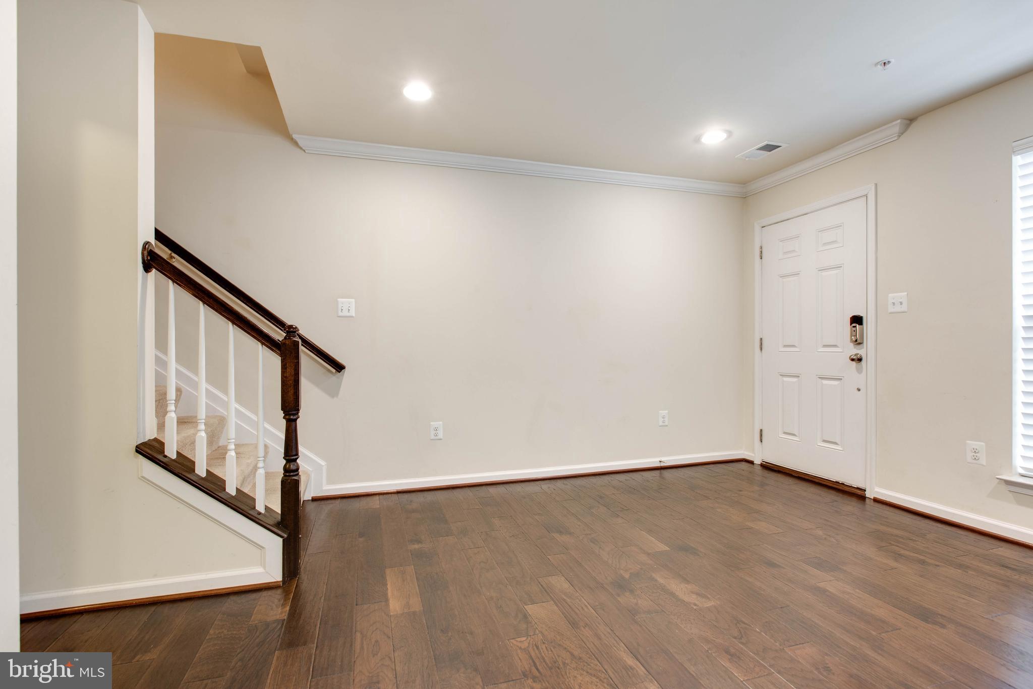 7048 Foxton Way Hanover, MD 21076 - Photo 5 of 52 a view of an empty room with wooden floor