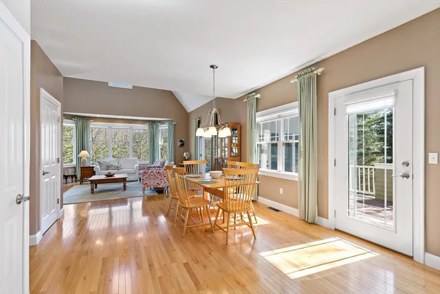 a living room with furniture large window and wooden floor