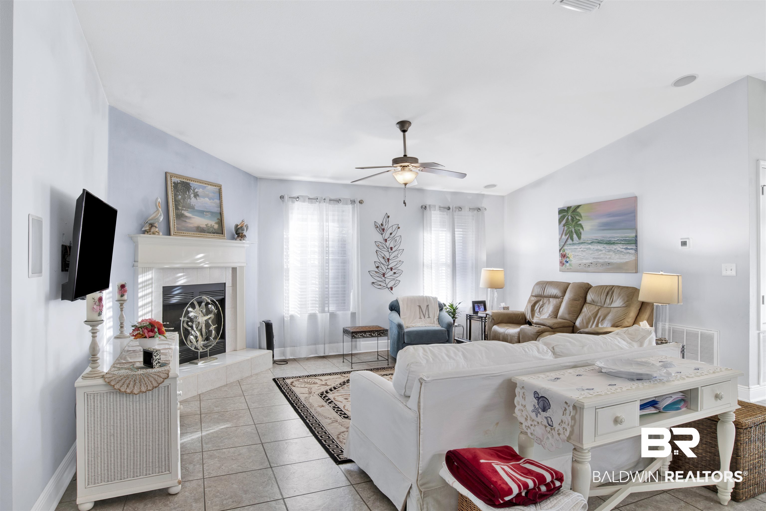 314 Blackfriars Street Fairhope, AL 36532 - Photo 8 of 25 Tiled living room featuring a tiled fireplace, vaulted ceiling, and ceiling fan