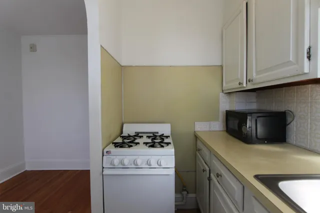 a kitchen with a stove and a microwave