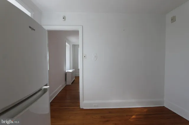 a view of a room with wooden floor