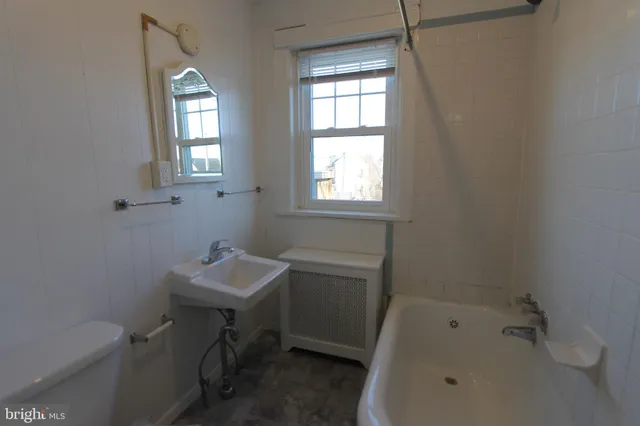 a bathroom with a sink toilet and tub