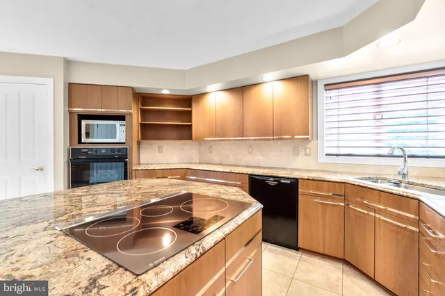 a kitchen that has a sink and a stove in it