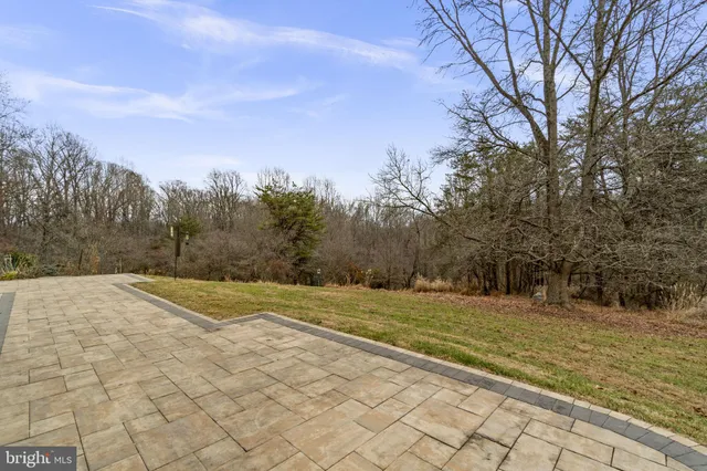 a view of a house with a yard and tree s