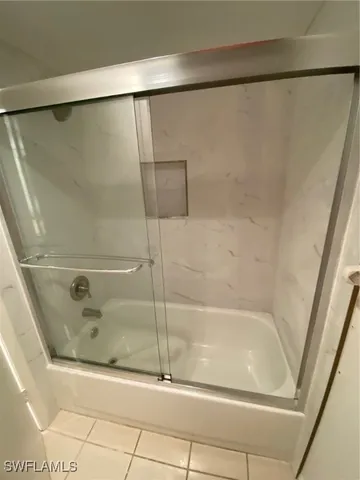 a bathroom with a tub and shower
