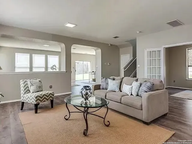 a living room with furniture and a large window