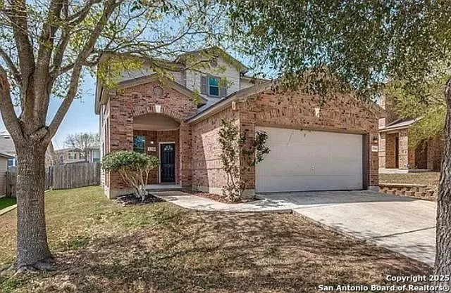 a view of a house with a trees and pathway