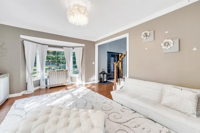 an aerial view of a house with table and chairs potted plants and large tree