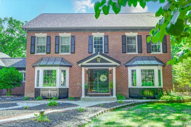 a kitchen with stainless steel appliances granite countertop a sink a stove and a wooden floors