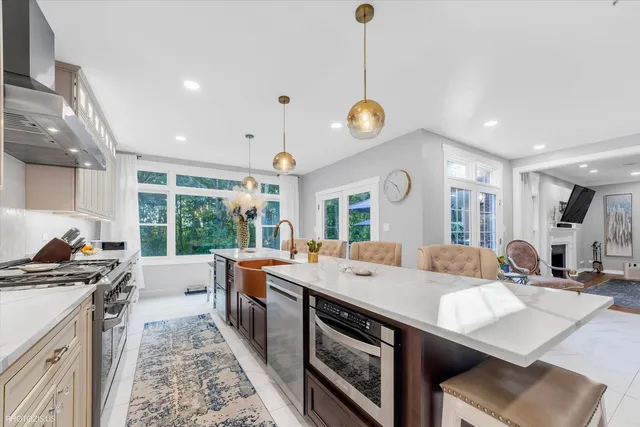 a view of a dining room with furniture a chandelier and wooden floor