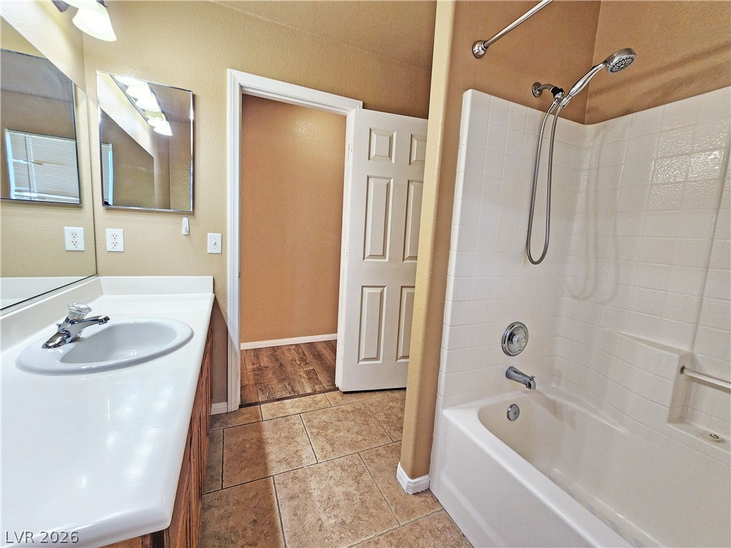 3680 Ravine Avenue Pahrump, NV 89048 - Photo 22 of 28 Full bathroom featuring baseboards, tile patterned floors, vanity, and shower / washtub combination