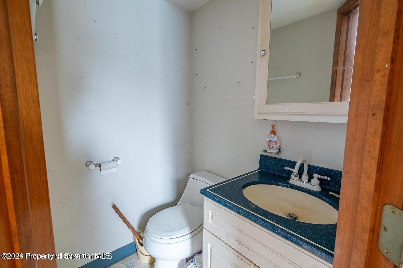 1777 Lamb Road Thompson, PA 18465 - Photo 24 of 31 a bathroom with a granite countertop sink and a mirror