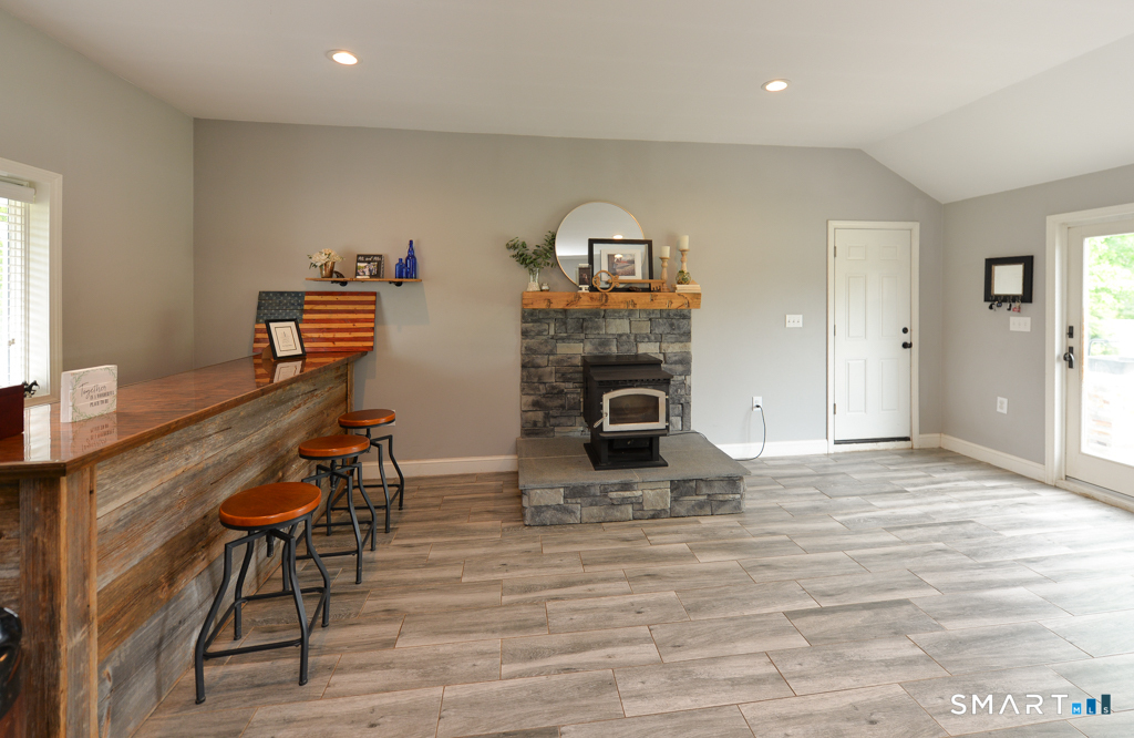 109 Harrison Lane Bethlehem, CT 06751 - Photo 10 of 28 a living room with furniture and a fireplace