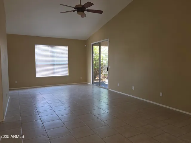 a view of a kitchen with a dishwasher a kitchen island a sink window and cabinets
