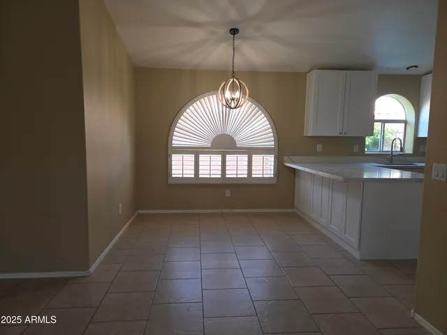 a kitchen with kitchen island granite countertop a sink and a stove