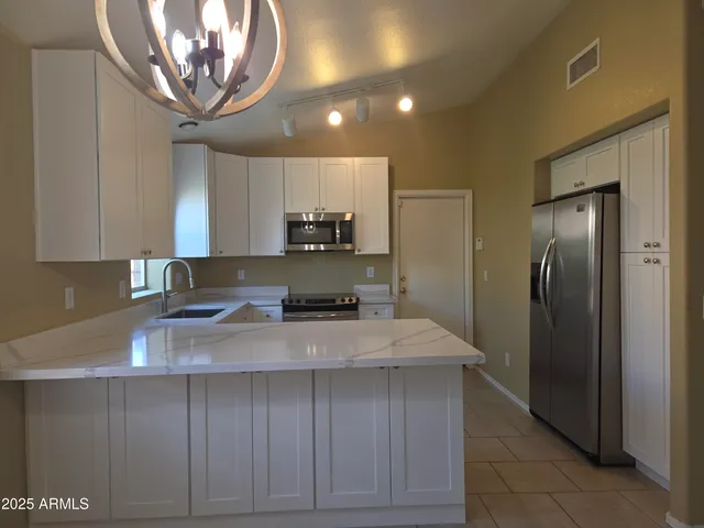 a kitchen with a sink a window and cabinets