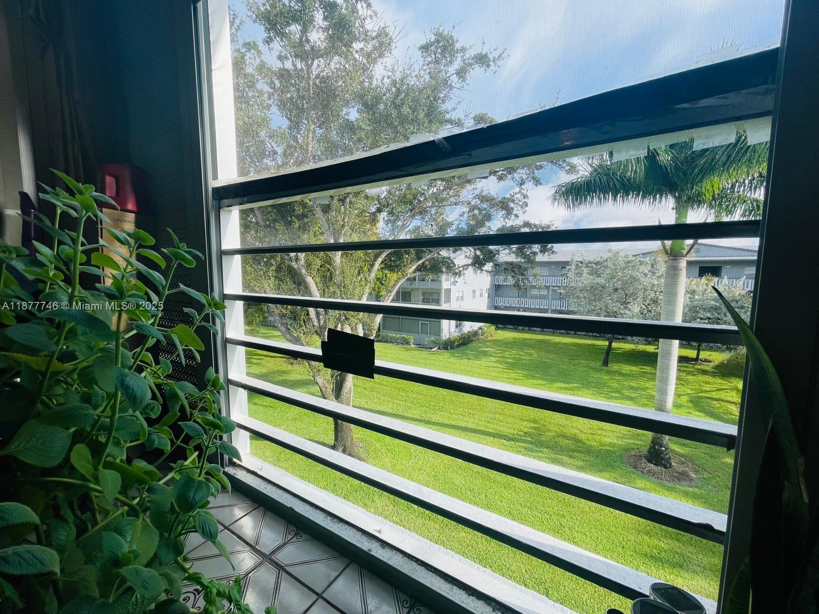 251 Suffolk F, Unit 251 Boca Raton, FL 33434 - Photo 11 of 25 a view of a window in a park