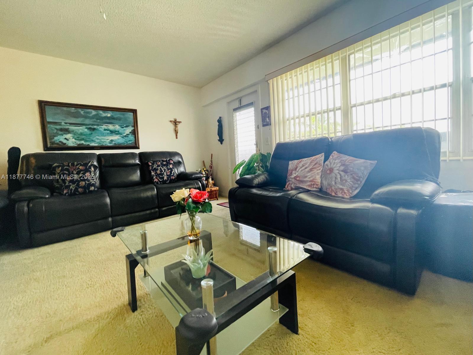 251 Suffolk F, Unit 251 Boca Raton, FL 33434 - Photo 4 of 25 a living room with furniture and a window