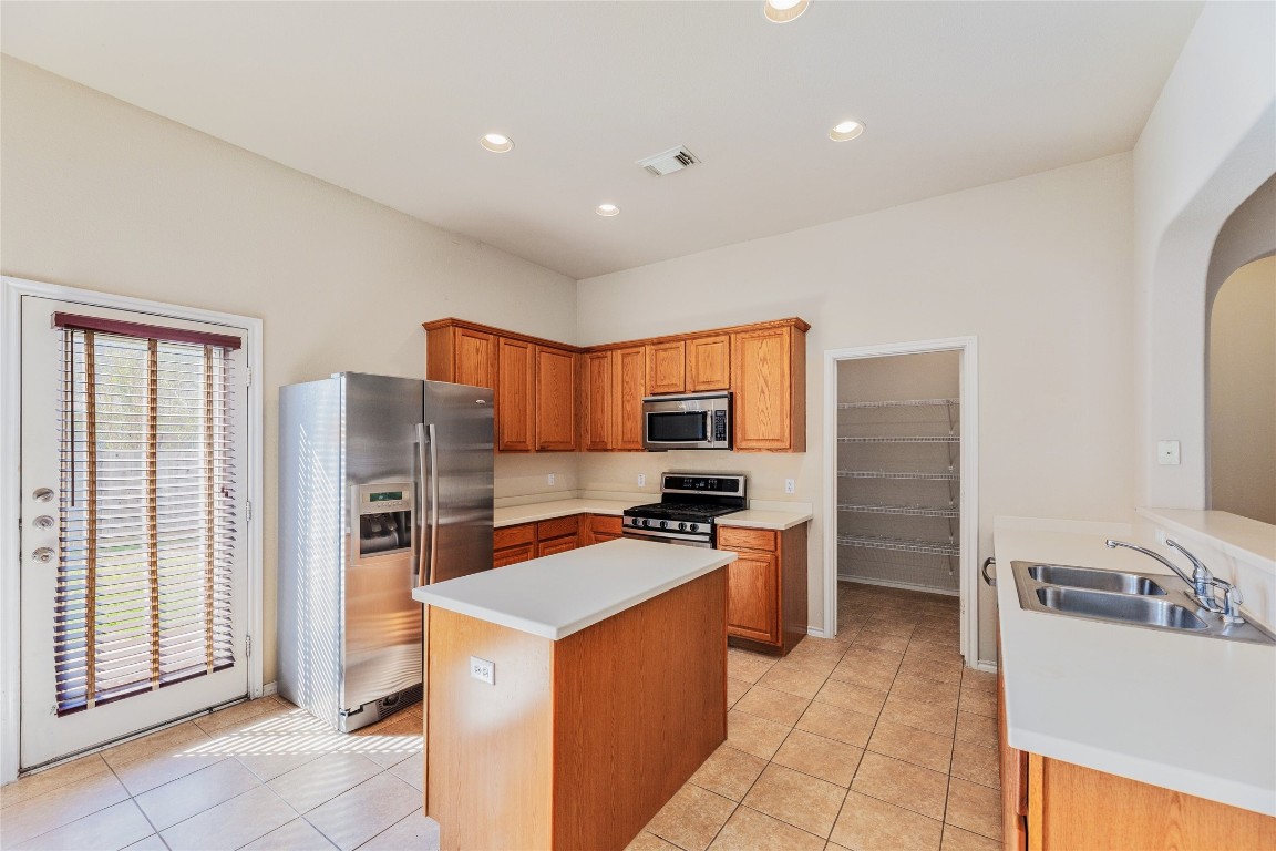 1613 Bowerton Drive Austin, TX 78754 - Photo 11 of 30 a kitchen with stainless steel appliances a refrigerator stove and sink