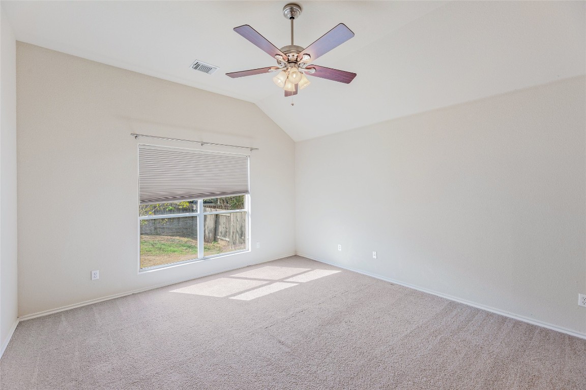 1613 Bowerton Drive Austin, TX 78754 - Photo 14 of 30 an empty room with chandelier fan and windows
