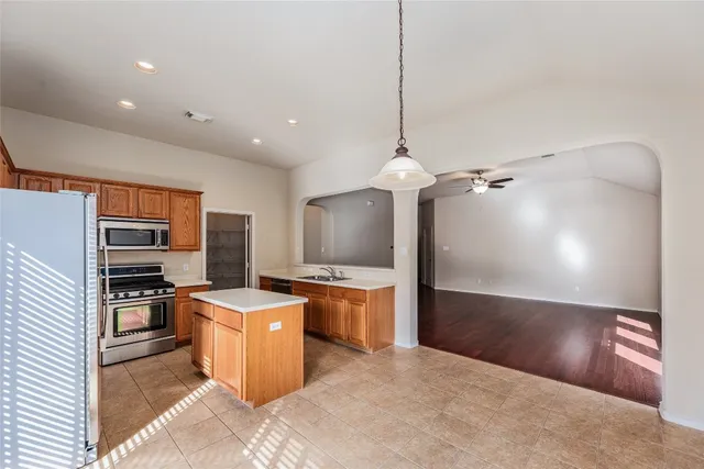 a kitchen with stainless steel appliances granite countertop a sink stove and refrigerator