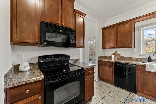 a kitchen with stainless steel appliances granite countertop wooden cabinets stove top oven and sink