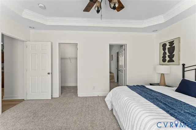 a bedroom with a large bed and painting on the wall