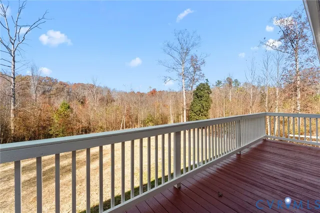 a balcony with wooden floor and fence