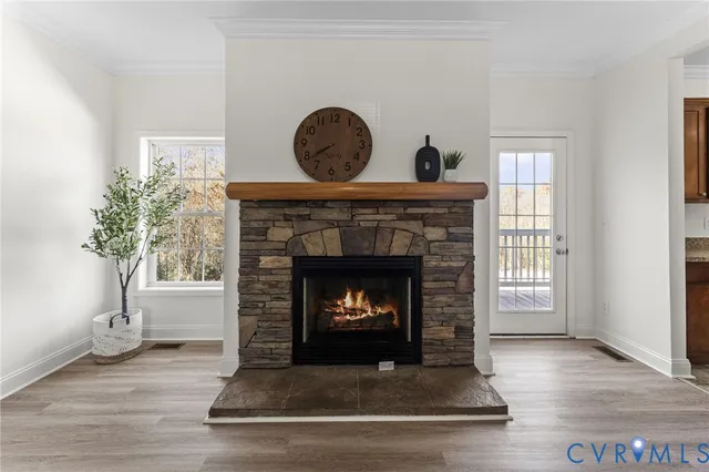 a living room with a fireplace and wooden floor