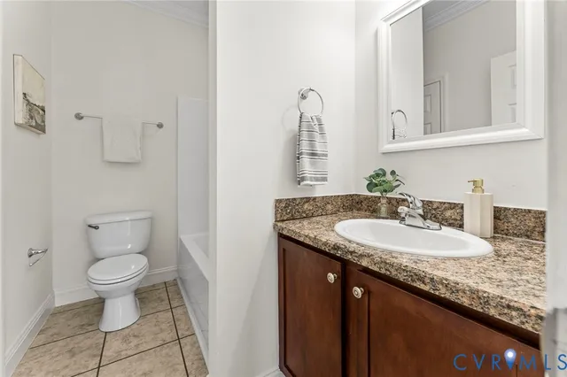 a bathroom with a granite countertop sink a toilet and a mirror