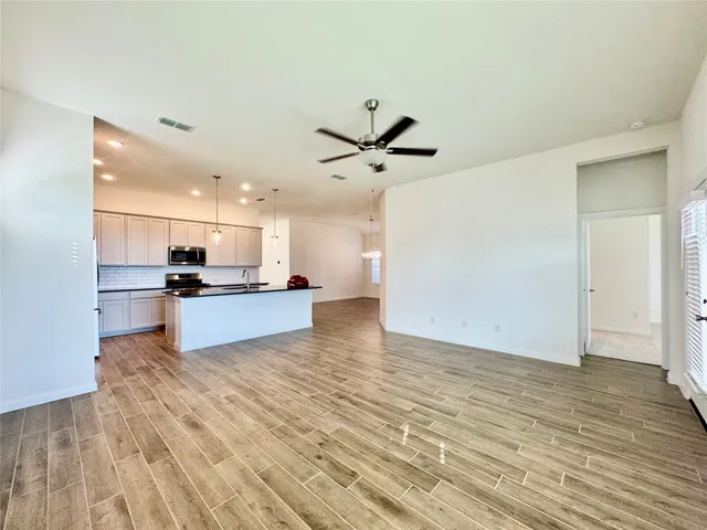 a view of kitchen with wooden floor and a sink