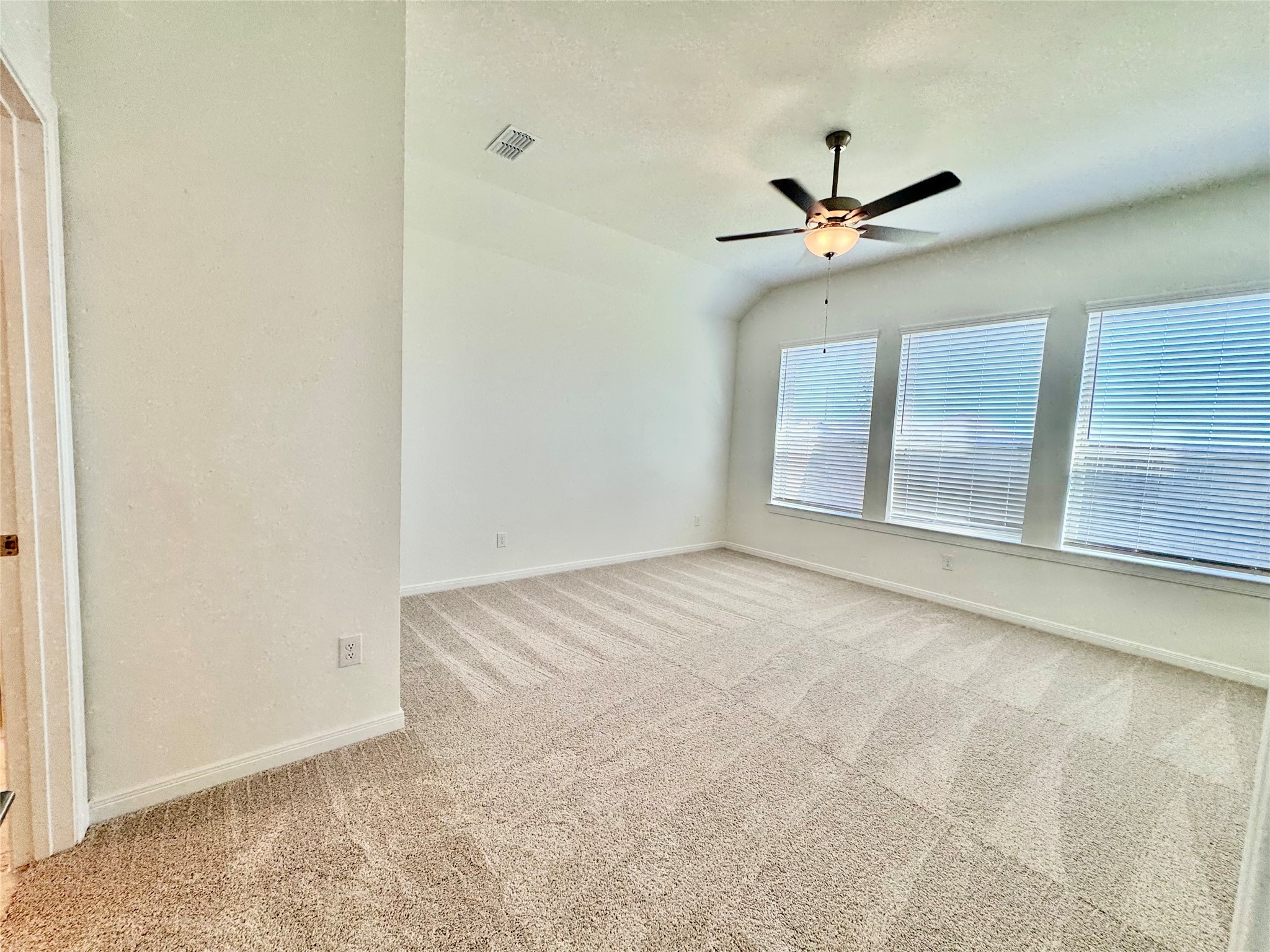 8923 Moose Trail Manvel, TX 77578 - Photo 12 of 20 an empty room with a ceiling fan and carpet